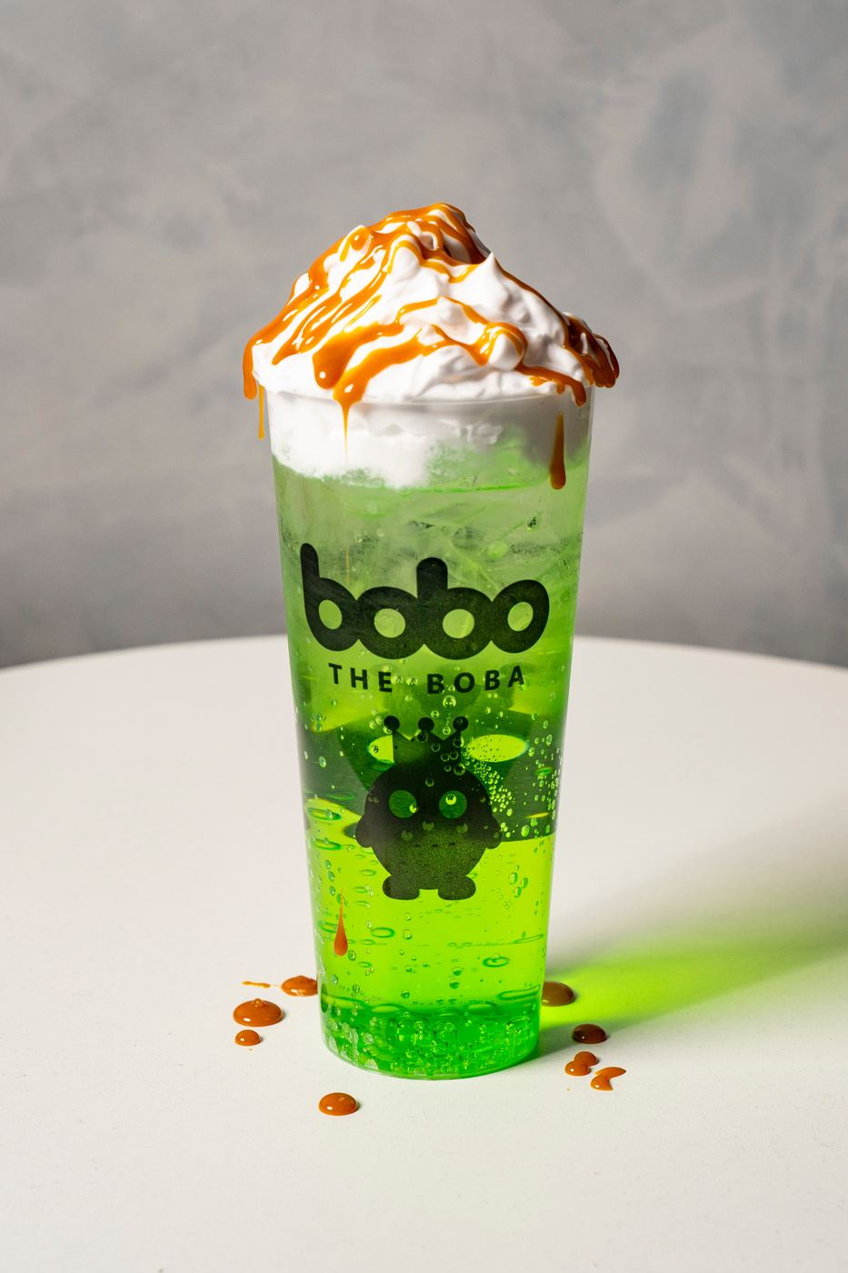Green apple soda with whipped cream and caramel drizzle