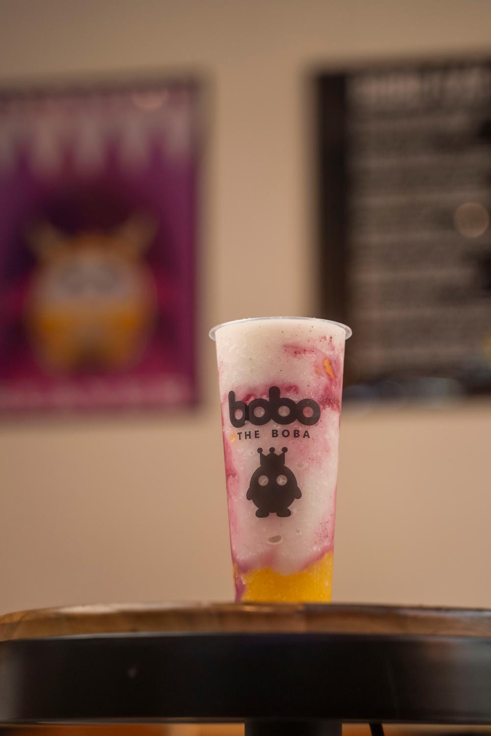 Mango berry smoothie on a table inside the shop
