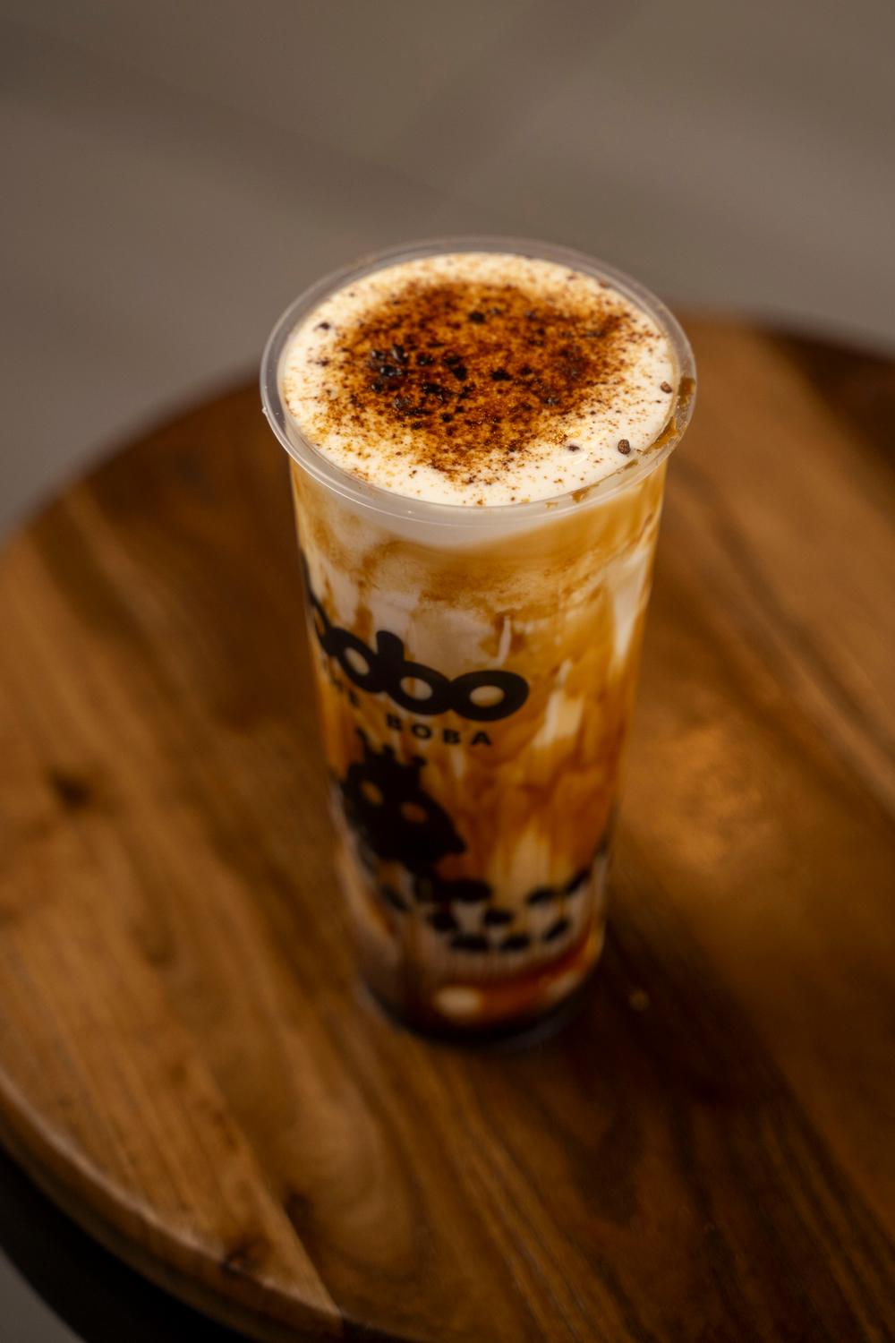 Creme brulee brown sugar boba on a wooden tray