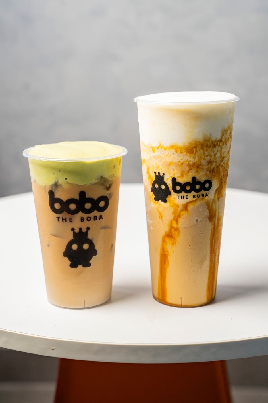 Two specialty milk teas with foam tops