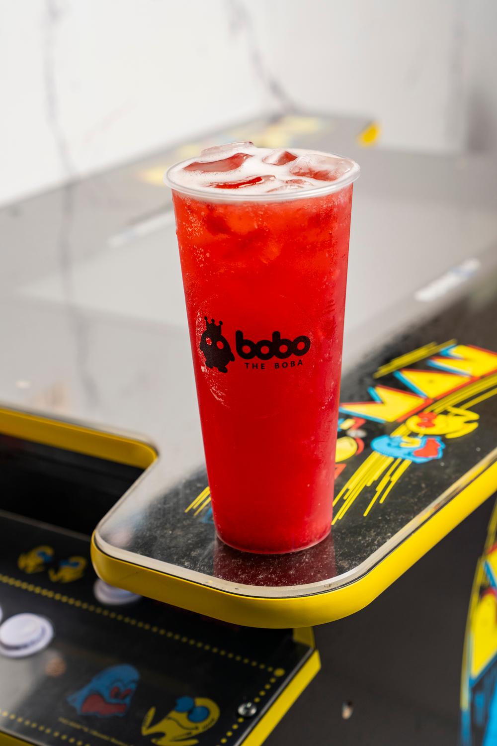 Strawberry fruit tea on an arcade cabinet