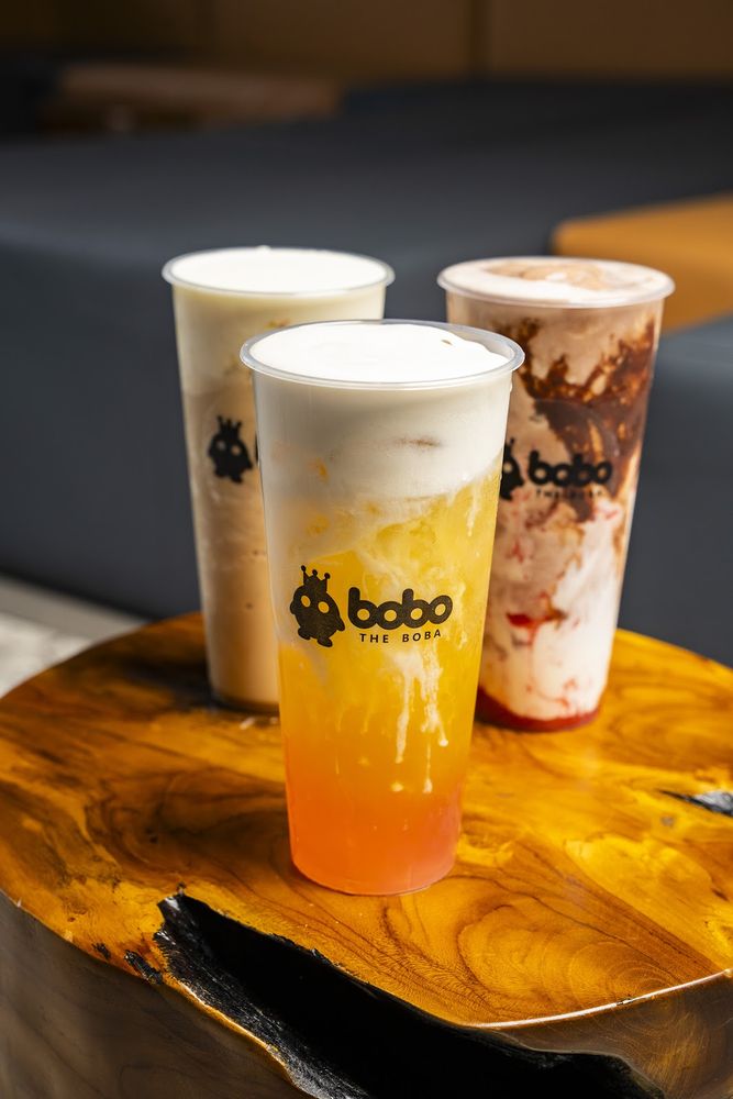 Trio of milk teas on a wooden serving block