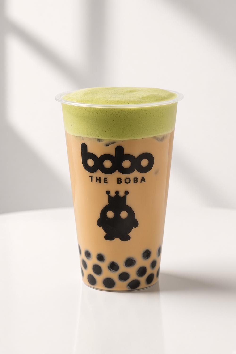 Milk tea with black boba topped with matcha foam