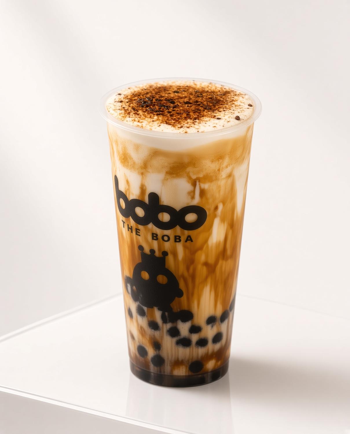 Brown sugar boba milk tea with cream and cocoa dusting