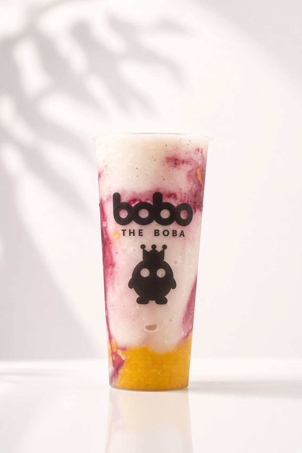 Mango and berry smoothie layered in a Bobo cup